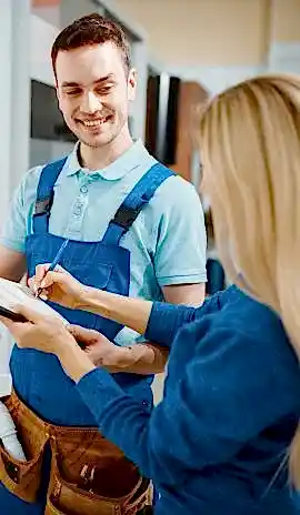2-male-plumber-and-female-customer-in-the-kitchen-EKTSSW7.jpg